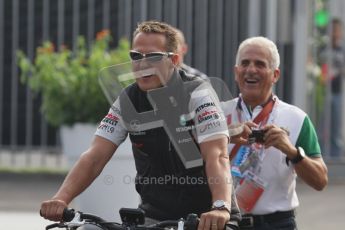 © Octane Photographic Ltd. 2011. Formula 1 World Championship – Italy – Monza – 11th September 2011. Race Day in the Paddock. Michael Schumacher riding his bike into the paddock. Digital Ref : 0193LW7D6405