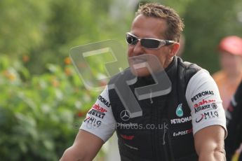 © Octane Photographic Ltd. 2011. Formula 1 World Championship – Italy – Monza – 11th September 2011. Race Day in the Paddock. Michael Schumacher riding his bike into the paddock. Digital Ref : 0193LW7D6408