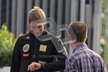 © Octane Photographic Ltd. 2011. Formula 1 World Championship – Italy – Monza – 11th September 2011. Race Day in the Paddock. Vitaly Petrov checks his watch as he walks through the paddock. Digital Ref : 0193LW7D6535