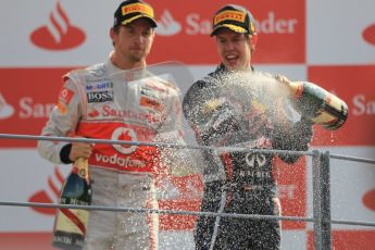 © Octane Photographic Ltd. 2011. Formula 1 World Championship – Italy – Monza – 11th September 2011 – Podium – Jenson Button (McLaren) watches Sebastian Vettel spray Champagne into the pitlane. Digital Ref : 0178CB1D4246
