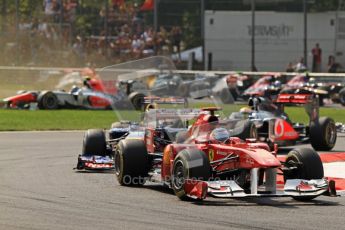 © Octane Photographic Ltd. 2011. Formula 1 World Championship – Italy – Monza – 11th September 2011 Viantonio Liutzi (HRT) arrives sideways on the grass leading to a huge collision as Fernando Alonso (Ferrari) and Sebastian Vettel (Red Bull) lead the pack on lap 1 – Race – Digital Ref : 0177CB7D7843