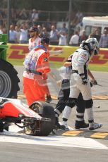 © Octane Photographic Ltd. 2011. Formula 1 World Championship – Italy – Monza – 11th September 2011 Viantonio Liutzi is lead away from his wrecked HRT after causing the huge 1st corner accident – Race – Digital Ref :  0177CB7D7888