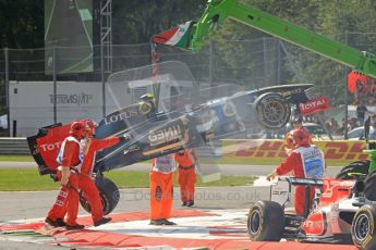 © Octane Photographic Ltd. 2011. Formula 1 World Championship – Italy – Monza – 11th September 2011 Vitaly Petrov's wrecked Renault is lifted clear of the race track after the 1st corner accident – Race – Digital Ref : 0177CB7D7916