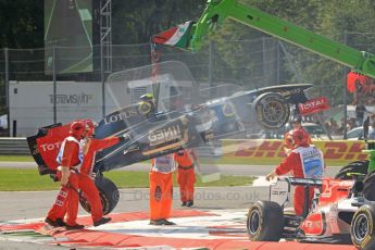 © Octane Photographic Ltd. 2011. Formula 1 World Championship – Italy – Monza – 11th September 2011 Vitaly Petrov's wrecked Renault is lifted clear of the race track after the 1st corner accident – Race – Digital Ref :  0177CB7D7916