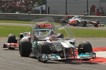 © Octane Photographic Ltd. 2011. Formula 1 World Championship – Italy – Monza – 11th September 2011 Michael Schumacher bounces his Mercedes onto 3 wheels under pressure from Lewis Hamilton's McLaren – Race – Digital Ref :  0177CB7D8081