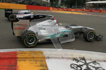 © Octane Photographic Ltd. 2011. Formula One Belgian GP – Spa – Sunday 28th August 2011 – Race. Michael Schumacher gets past Pastor Maldonado through La Source. Digital Reference : 0168lw7d9299