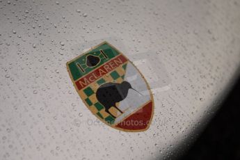 © Octane Photographic 2011 – Goodwood Revival 17th September 2011. McLaren badge in the rain. Digital Ref : 0179CB1D4285