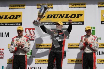 © Octane Photographic Ltd. BTCC - Round Two - Donington Park - Race 1. Sunday 15th April 2012. Mat Jackson, hoists the winners trophy as Matt Neal and Gordon Shedden applaud on the podium. Digital ref : 0295lw7d4197