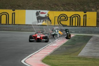 © 2012 Octane Photographic Ltd. Hungarian GP Hungaroring - Friday 27th July 2012 - F1 Practice 2. Marussia MR01 - Charles Pic being chased by a sideways Caterham of Heikki Kovalainen. Digital Ref : 0426lw1d6188