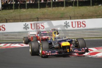 © 2012 Octane Photographic Ltd. Hungarian GP Hungaroring - Sunday 29th July 2012 - F1 Race. Red Bull RB8 - Sebastian Vettel bounces high over the curbing whilst being chased by the Ferrari F2012 of Fernando Alonso. Digital Ref :