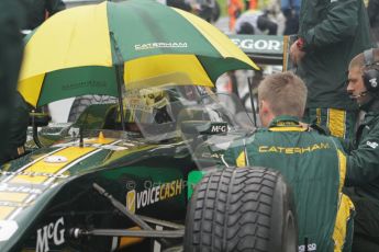 © 2012 Octane Photographic Ltd. British GP Silverstone - Saturday 7th July 2012 - GP2 Race 1, © 2012 Octane Photographic Ltd. British GP Silverstone - Friday 6th July 2012 - GP2 Practice - Caterham Racing - Giedo van der Garde shelters from the rain on the grid. Digital Ref : 0400lw7d5922