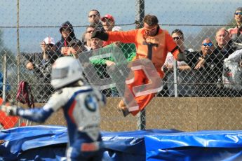 © Octane Photographic Ltd 2012. World Superbike Championship – European GP – Donington Park, Sunday 13th May 2012. Race 2. One of the marshals leaps into action after the Melandri/Haslam crash on the final corner of the final lap. Digital Ref : 0337cb1d5836