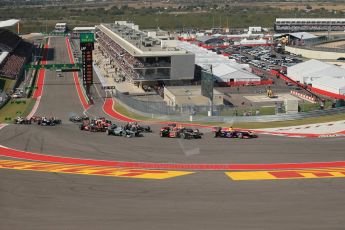 World © Octane Photographic Ltd. F1 USA GP, Austin, Texas, Circuit of the Americas (COTA), Sunday 17th November 2013 - Race. Sebastian Vettel's Red bull leads the pack into the 1st corner as Romain Grosjean in his Lotus E31 puts his move on around his outside. Digital Ref : 0861lw1d5906