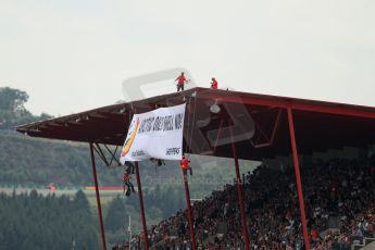 World © Octane Photographic Ltd. F1 Belgian GP - Spa-Francorchamps, Sunday 25th August 2013 - Podium. Anti Shell Arctic drill activists Greenpeace "Savethearctic.org" protesting during the race from the main straight grandstand. Digital Ref :