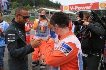 World © Octane Photographic Ltd. F1 Belgian GP - Spa-Francorchamps, Sunday 25th August 2013 - Race Build up. Mercedes AMG Petronas F1 W04 – Lewis Hamilton signs a marshall's tabard. Digital Ref :