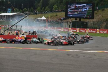 World © Octane Photographic Ltd. F1 Belgian GP - Spa-Francorchamps, Sunday 25th August 2013 - Race. Sebastian Vettel (Infiniti Red Bull Racing) and Jenson Button (Vodafone McLaren Mercedes) put a move around the out side of Nico Rosberg (Mercedes AMG Petronas) in turn 1. Digital Ref : 0797lw1d0714