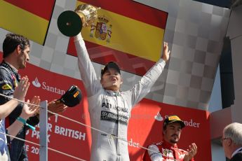 World © Octane Photographic Ltd. F1 British GP - Silverstone, Sunday 30th June 2013 - Race. Mercedes AMG Petronas F1 W04 - Nico Rosberg celebrates his win on the podium. Digital Ref : 0734lw1d2826