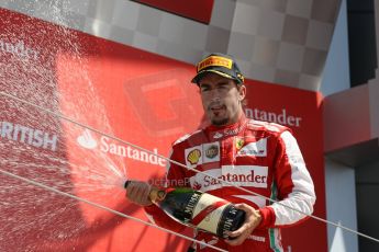 World © Octane Photographic Ltd. F1 British GP - Silverstone, Sunday 30th June 2013 - Race. Scuderia Ferrari F138 - Fernando Alonsosprays his champagne from the podium. Digital Ref : 0734lw1d2883