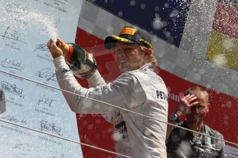 World © Octane Photographic Ltd. F1 British GP - Silverstone, Sunday 30th June 2013 - Race. Mercedes AMG Petronas F1 W04 - Nico Rosberg celebrates his win on the podium. Digital Ref : 0734lw1d2897