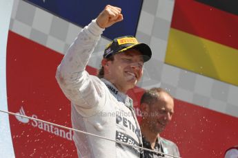 World © Octane Photographic Ltd. F1 British GP - Silverstone, Sunday 30th June 2013 - Race. Mercedes AMG Petronas F1 W04 - Nico Rosberg celebrates his win on the podium. Digital Ref : 0734lw1d2958