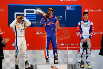 World © Octane Photographic Ltd./Chris Enion. GP2 British GP, Silverstone, Sunday 30th June 2013. Race 2 winner Jon Lancaster - Hilmer Motorsport celebrates on the podium with James Calado and Rio Haryanto. Digital Ref : 0732ce1d9582