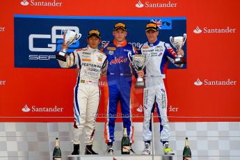 World © Octane Photographic Ltd./Chris Enion. GP2 British GP, Silverstone, Sunday 30th June 2013. Race 2 winner Jon Lancaster - Hilmer Motorsport celebrates on the podium with James Calado and Rio Haryanto. Digital Ref : 0732ce1d9584