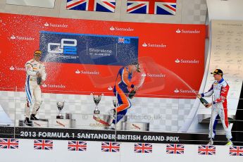 World © Octane Photographic Ltd./Chris Enion. GP2 British GP, Silverstone, Sunday 30th June 2013. Race 2 winner Jon Lancaster - Hilmer Motorsport celebrates on the podium with James Calado and Rio Haryanto. Digital Ref : 0732ce1d9601