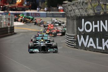 World © Octane Photographic Ltd. F1 Monaco GP, Monte Carlo - Sunday 26th May - Race. The Mercedes AMG Petronas F1 W04 of Nico Rosberg leads Lewis Hamilton and the Infiniti Red Bull Racing RB9 of Sebastian Vettel up the hill after Ste.Devote on the 1st lap. Digital Ref : 0711lw1d0869