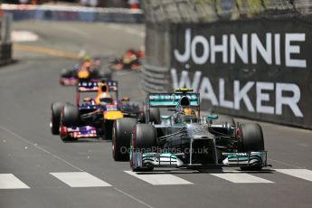 World © Octane Photographic Ltd. F1 Monaco GP, Monte Carlo - Sunday 26th May - Race. The Mercedes AMG Petronas F1 W04 of Lewis Hamilton under pressure from the Infiniti Red Bull Racing RB9 of Sebastian Vettel up the hill after Ste.Devote on the 2nd lap. Digital Ref : 0711lw1d0993