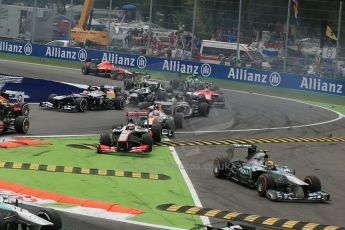 World © Octane Photographic Ltd. F1 Italian GP - Monza, Sunday 8th September 2013 - Race. Mercedes AMG Petronas F1 W04 – Lewis Hamilton, an airborne Vodafone McLaren Mercedes MP4/28 of Jenson Button and Sahara Force India VJM06 - Paul di Resta all cut the apex. Digital Ref : 0824lw1d6122