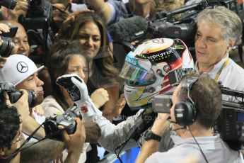 World © Octane Photographic Ltd. Sunday 23rd November 2014. Abu Dhabi Grand Prix - Yas Marina Circuit - Formula 1 Podium. Mercedes AMG Petronas – Lewis Hamilton - Race winner and 2014 World Champion greeting his team and family. Digital Ref: 1173CB1D0531