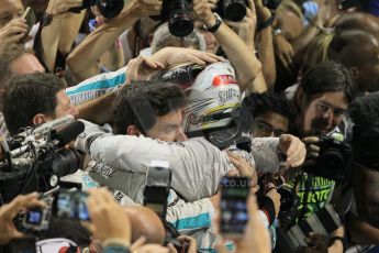 World © Octane Photographic Ltd. Sunday 23rd November 2014. Abu Dhabi Grand Prix - Yas Marina Circuit - Formula 1 Podium. Mercedes AMG Petronas – Lewis Hamilton - Race winner and 2014 World Champion greeting his team and family. Digital Ref: 1173CB1D0552