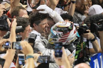 World © Octane Photographic Ltd. Sunday 23rd November 2014. Abu Dhabi Grand Prix - Yas Marina Circuit - Formula 1 Podium. Mercedes AMG Petronas – Lewis Hamilton - Race winner and 2014 World Champion greeting his team and family. Digital Ref: 1173CB1D0573