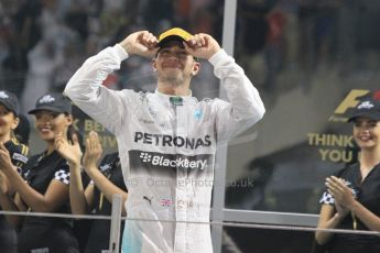 World © Octane Photographic Ltd. Sunday 23rd November 2014. Abu Dhabi Grand Prix - Yas Marina Circuit - Formula 1 Podium. Mercedes AMG Petronas – Lewis Hamilton - Race winner and 2014 World Champion. Digital Ref: 1173CB1D0733