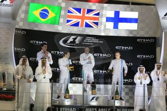 World © Octane Photographic Ltd. Sunday 23rd November 2014. Abu Dhabi Grand Prix - Yas Marina Circuit - Formula 1 Podium. Mercedes AMG Petronas – Lewis Hamilton - Race winner and 2014 World Champion and Williams Racing - Felipe Massa (2nd) and Valtteri Bottas (3rd). Digital Ref: 1173CB1D0840