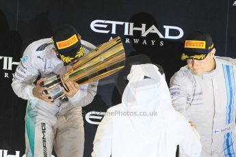 World © Octane Photographic Ltd. Sunday 23rd November 2014. Abu Dhabi Grand Prix - Yas Marina Circuit - Formula 1 Podium. Mercedes AMG Petronas – Lewis Hamilton - Race winner and 2014 World Champion. Digital Ref: 1173CB1D0948