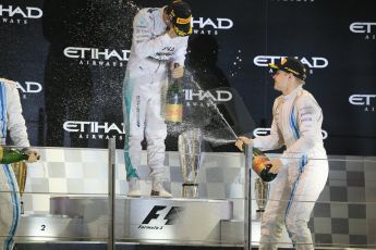 World © Octane Photographic Ltd. Sunday 23rd November 2014. Abu Dhabi Grand Prix - Yas Marina Circuit - Formula 1 Podium. Mercedes AMG Petronas – Lewis Hamilton - Race winner and 2014 World Champion and Williams Racing - Valtteri Bottas (3rd). Digital Ref: 1173CB1D1132