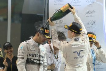 World © Octane Photographic Ltd. Sunday 23rd November 2014. Abu Dhabi Grand Prix - Yas Marina Circuit - Formula 1 Podium. Mercedes AMG Petronas – Lewis Hamilton - Race winner and 2014 World Champion and Williams Racing - Felipe Massa (2nd) and Valtteri Bottas (3rd). Digital Ref: 1173CB1D1311