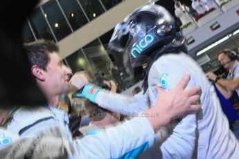 World © Octane Photographic Ltd. Sunday 23rd November 2014. Abu Dhabi Grand Prix - Yas Marina Circuit - Formula 1 Podium. Mercedes AMG Petronas – Lewis Hamilton - Race winner and 2014 World Champion greeting his team and family. Digital Ref: 1173LB1D7675