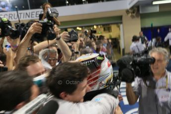 World © Octane Photographic Ltd. Sunday 23rd November 2014. Abu Dhabi Grand Prix - Yas Marina Circuit - Formula 1 Podium. Mercedes AMG Petronas – Lewis Hamilton - Race winner and 2014 World Champion greeting his team and family. Digital Ref: 1173LB1D7700