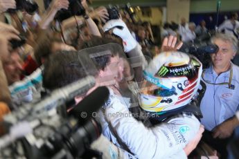 World © Octane Photographic Ltd. Sunday 23rd November 2014. Abu Dhabi Grand Prix - Yas Marina Circuit - Formula 1 Podium. Mercedes AMG Petronas – Lewis Hamilton - Race winner and 2014 World Champion greeting his team and family. Digital Ref: 1173LB1D7706