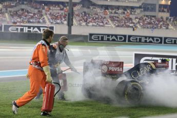 World © Octane Photographic Ltd. Sunday 23rd November 2014. Abu Dhabi Grand Prix - Yas Marina Circuit - Formula 1 Race. Lotus F1 Team E22 being extinguished by the fire marshals – Pastor Maldonado. Digital Ref: