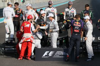 World © Octane Photographic Ltd. Sunday 23rd November 2014. Abu Dhabi Grand Prix - Yas Marina Circuit - End of season Formula 1 Drivers line up, Grosjean and Maldonado - Lotus F1 Team, Sutil, and Gutierrez - Sauber F1 Team, Stevens and Kobayashi - Caterham F1 Team, Button and Magnussen - McLaren Mercedes, Hulkenberg and Perez - Sahara Force India, Vergne and Kvyat - Toro Rosso, Alonso and Raikkonen - Scuderia Ferrari, Hamilton and Rosberg - Mercedes AMG Petronas, Vettel and Ricciardo - Infiniti Red Bull Racing and Massa and Bottas - Williams Racing. Digital Ref: