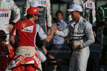 World © Octane Photographic Ltd. Sunday 23rd November 2014. Abu Dhabi Grand Prix - Yas Marina Circuit - End of season Formula 1 Drivers line up, Fernando Alonso and Nico Rosberg. Digital Ref: