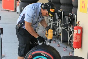 World © Octane Photographic Ltd. Wednesday 26th November 2014. Abu Dhabi Testing - Yas Marina Circuit. Pirelli technician with Mercedes wheel Digital Ref : 1175CB1D9152