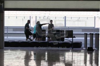 World © Octane Photographic Ltd. 2014 Formula 1 Abu Dhabi Grand Prix, Formula 1 setup, Wednesday 19th November 2014. Empty pit garage with Caterham, Mercedes and McLaren personnel. Digital Ref : 1153CB1DL4718