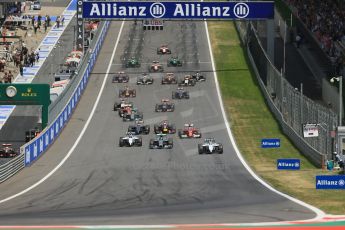 World © Octane Photographic Ltd. Sunday 22nd June 2014. Red Bull Ring, Spielberg - Austria - Formula 1 Race. The Williams Martini Racing FW36 of Felipe Massa leads the pack away on the opening lap as Rosberg's Mercedes dives past Bottas. Digital Ref: 1000LB1D5008