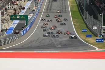 World © Octane Photographic Ltd. Sunday 22nd June 2014. Red Bull Ring, Spielberg - Austria - Formula 1 Race. The Williams Martini Racing FW36 of Felipe Massa leads the pack away on the opening lap as Rosberg's Mercedes dives past Bottas. Digital Ref: 1000LB1D5011