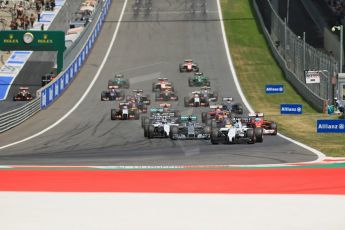 World © Octane Photographic Ltd. Sunday 22nd June 2014. Red Bull Ring, Spielberg - Austria - Formula 1 Race. The Williams Martini Racing FW36 of Felipe Massa leads the pack away on the opening lap as Rosberg's Mercedes dives past Bottas. Digital Ref: 1000LB1D5025