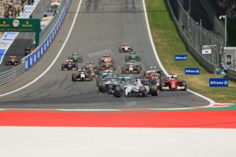World © Octane Photographic Ltd. Sunday 22nd June 2014. Red Bull Ring, Spielberg - Austria - Formula 1 Race. The Williams Martini Racing FW36 of Felipe Massa leads the pack away on the opening lap as Rosberg's Mercedes dives past Bottas. Digital Ref: 1000LB1D5028
